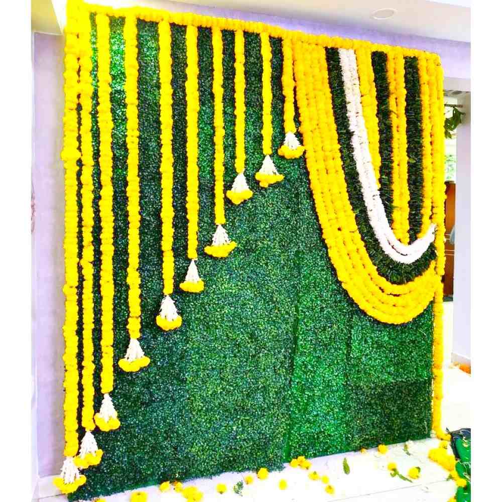 green-grass-backdrop-and-flower-decorations-for-baby-shower-in